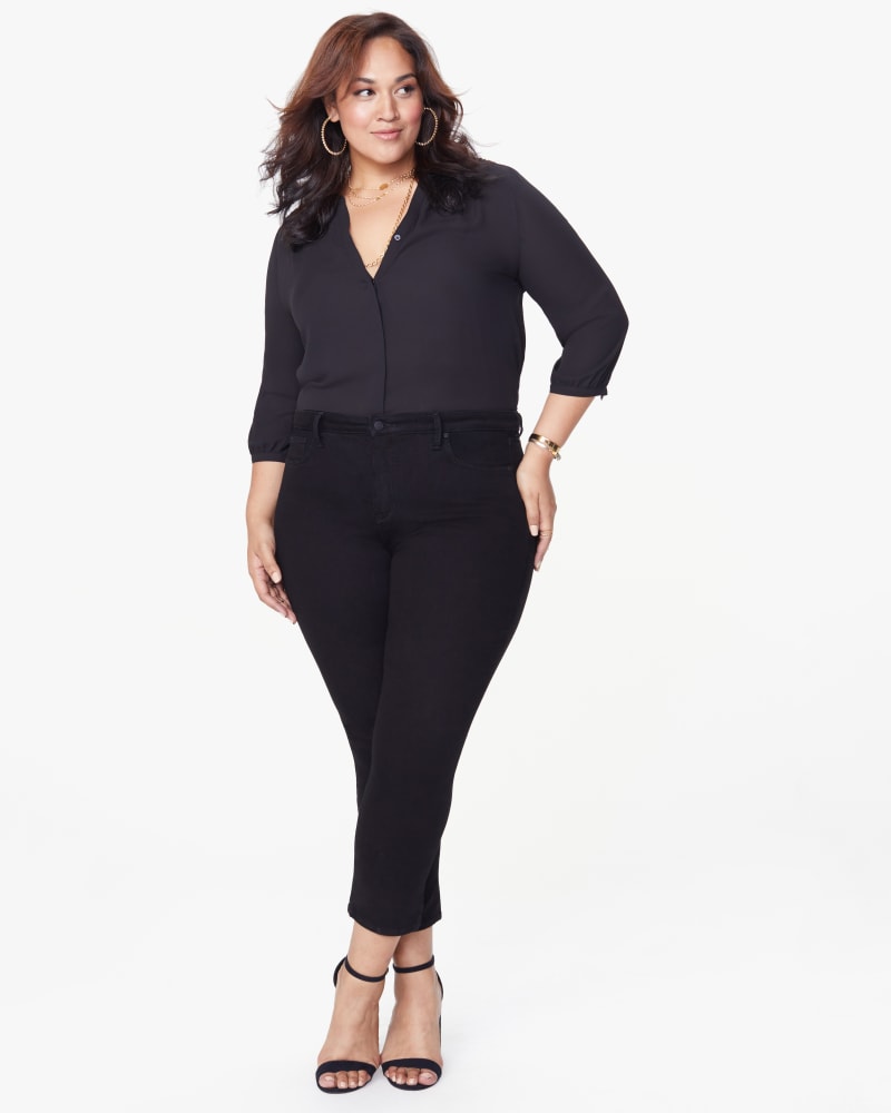 Front of a model wearing a size 14 Sheri Slim Leg Crop Jean in Black by NYDJ. | dia_product_style_image_id:187683